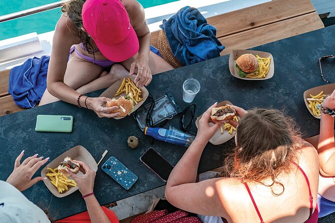 Blue Lagoon and 3 Island Boat Tour with Food and Drinks Included - Lunch on the water: burgers with fries, donuts for breakfast, and unlimited wine