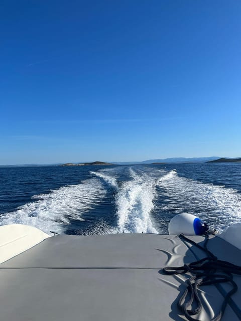 Split: 5 Islands Full-Day Tour to Blue Cave, Vis & Hvar - Stiniva Cove: cliff views from the boat and a quick sightseeing pause